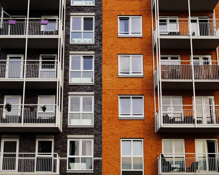 Brick and glass rental apartment building with balconies